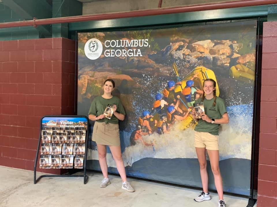 Interns in front of one of Whitewater rafting banners